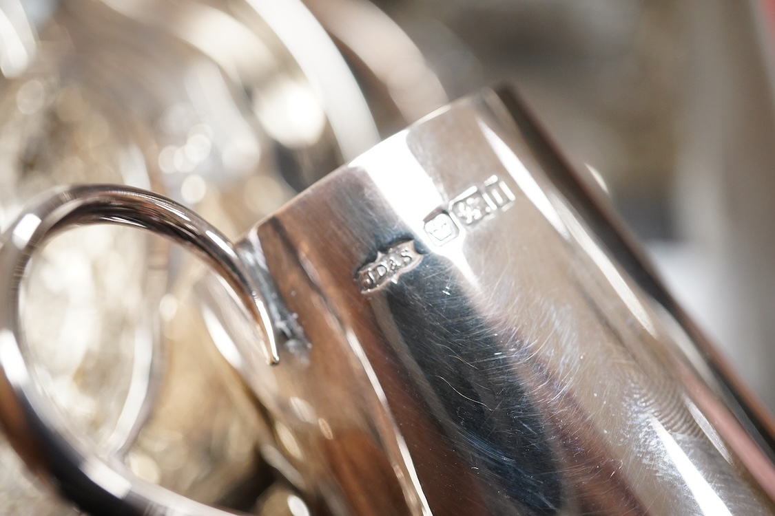 Sundry silver including two George V silver sauce boats, a silver café au lait pot, a small silver cream jug, three small silver dishes, a silver mounted glass sugar sifter and a silver mounted glass ashtray.